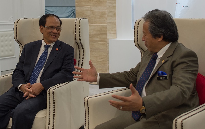ASEAN Secretary General Le luong Minh (L) and Malaysian Foreign Minister Anifah Aman speak prior to a meeting at the foreign ministry in Putrajaya on January 7, 2015. MOHD RASFAN/AFP/Getty Images.