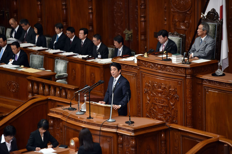 Japan's Prime Minister Shinzo Abe delivers his policy speech to the Lower House of the National Diet in Tokyo on September 29, 2014. YOSHIKAZU TSUNO/AFP/Getty Images.